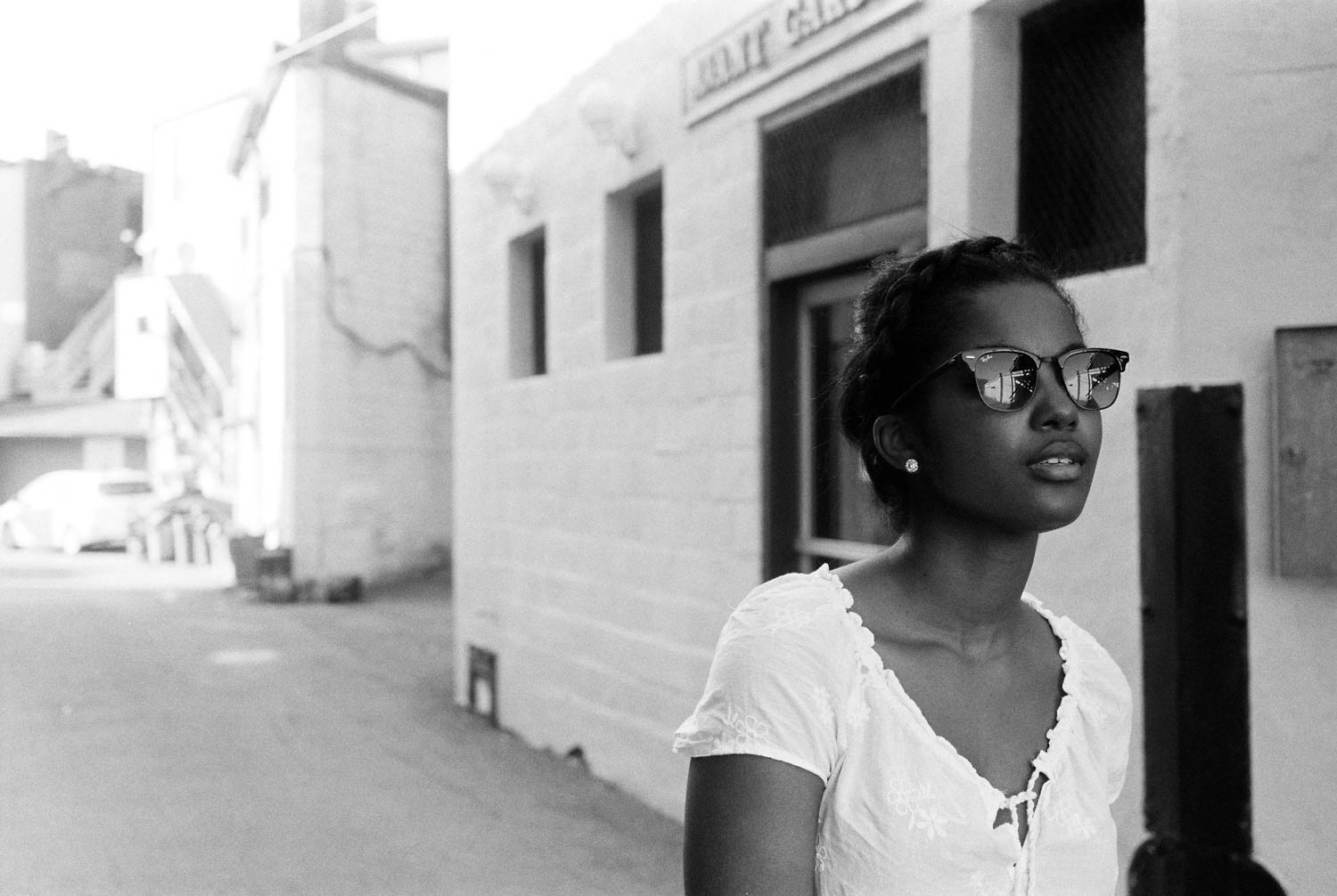 A picture of Jonelle wearing sunglasses, photographed with a Leica M2 on Ilford HP5+