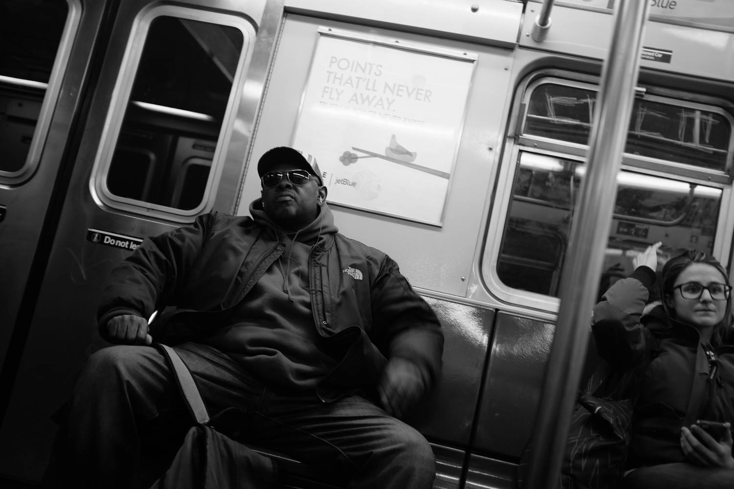 A man riding the New York City subway.