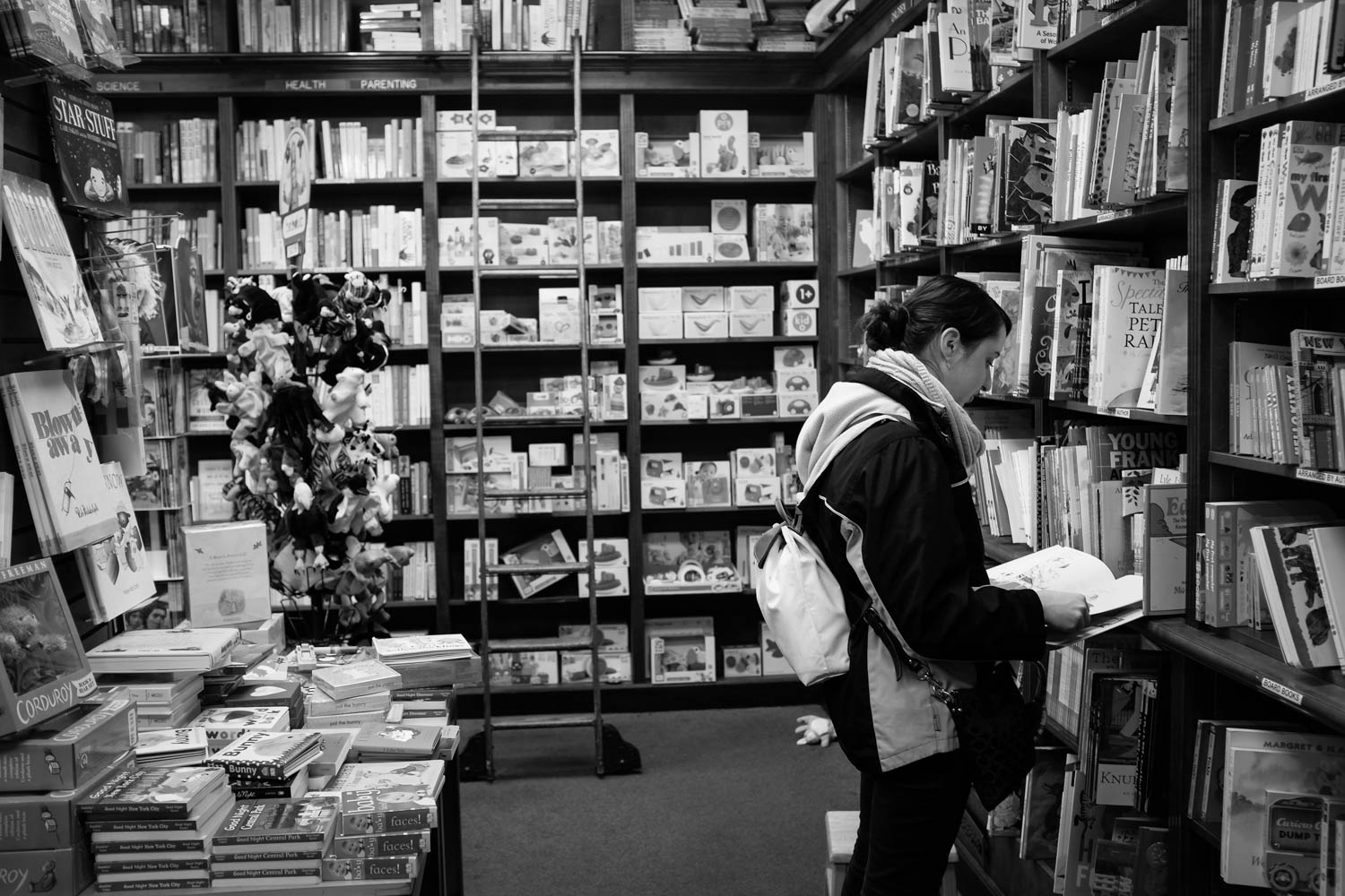 A girl flipping through the pages of a book at a local bookstore in Manhattan.